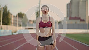 Female athlete starting her sprint on a running track. Runner taking off from the starting blocks on running track