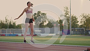 Female athlete starting her sprint on a running track. Runner taking off from the starting blocks on running track