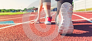 Female athlete on the starting line of a stadium track