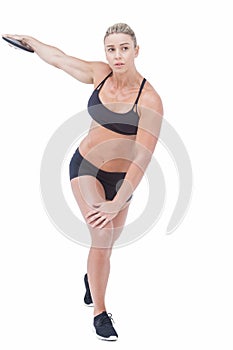 Female athlete throwing discus