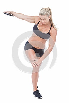 Female athlete throwing discus