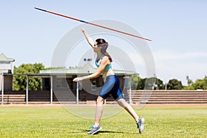 Female athlete throwing a javelin photo