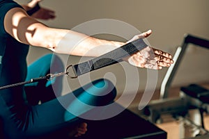 Female athlete using Pilates equipment at the gym showcasing her active and healthy lifestyle