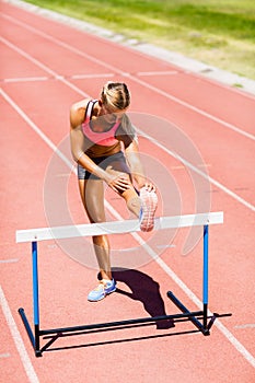 Female athlete warming up on running track