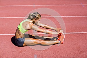 Female athlete warming up on the running track