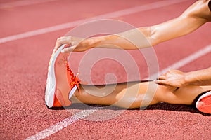 Female athlete warming up on the running track