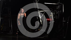 Female athlete working out with heavy ropes at the gym.