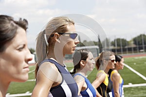 Female Athletes Standing In Line On Field