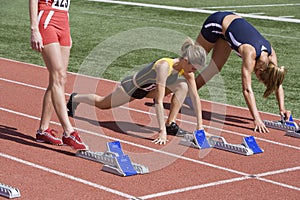 Female Athletes Warming Up At Starting Line