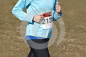 Female athletic runner on a cross country race. Outdoor circuit