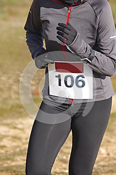 Female athletic runner on a cross country race. Outdoor circuit