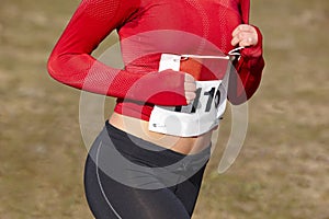 Female athletic runner with sweat. Cross country race. Outdoor c