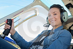 Female aviator in cockpit