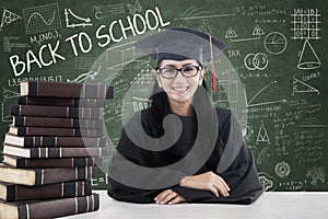 Female bachelor and books in class