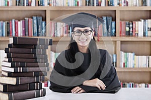 Female bachelor and books in library