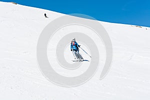 Female back-country skier tackling a steep slope.