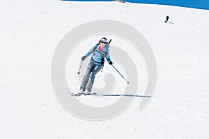 Female back-country skier tackling a steep slope.