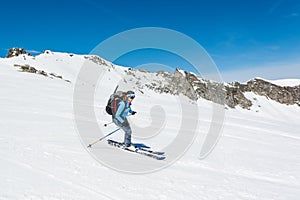 Female back-country skier tackling a steep slope.