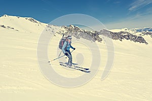 Female back-country skier tackling a steep slope.