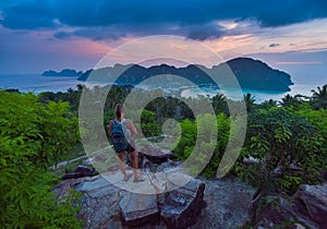 Female Backpacker admires beautiful landscape of the Ko Phi Phi  after sunset, Thailand