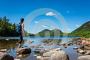 Female backpacker exploring Jordan Pond in Maine