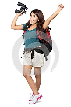 Female backpacker going on vacation with backpack and camera