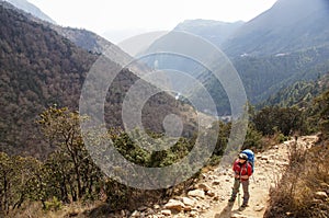 Female backpacker hikes trail
