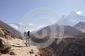 Female backpacker hikes trail photo