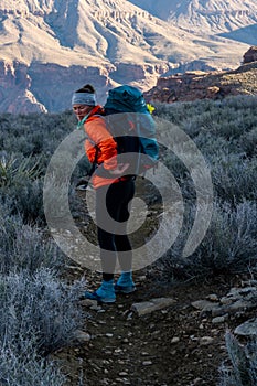 Female Backpacker Reaching for Something In Her Pack