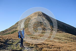 Female backpaker in the Carpathians mountains with backpack