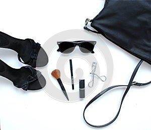 Female bag with cosmetics, sunglasses and shoes
