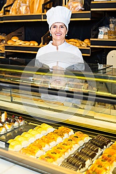 female baker offering fresh pastry