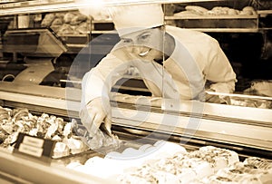 Female baker offering fresh pastry
