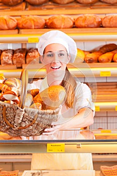 Female baker selling bread in her bakery