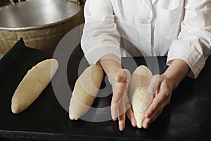 Female Baker Shaping Loaves photo