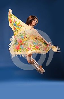 Female ballet dancer jumping with headscarf