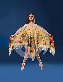 Female ballet dancer jumping with headscarf