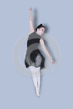 Female ballet dancer jumps with graceful pose