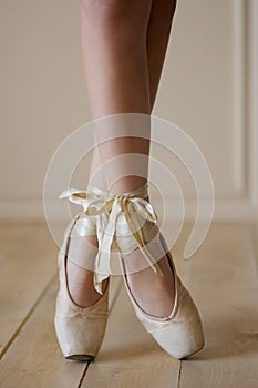 Female ballet dancer legs in white Pointe shoes