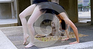 Female ballet dancer stretching before dancing 4k