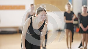 Female ballet dancer suffering ankle pain dancing in slow motion indoors. Portrait of Caucasian girl practicing ballroom