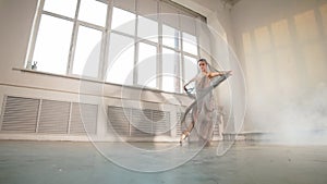 Female ballet dancer with white flowing fabric. Flow shapes and movement, slow motion