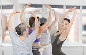 Female ballet instructor conducting group classes for amateurs