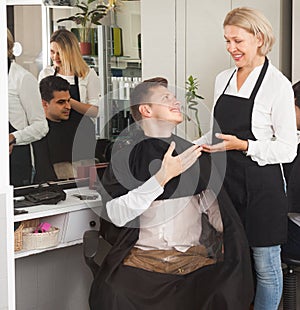 Female barbers cut men in the barbershop