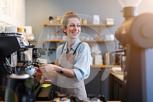 Female barista making coffee photo