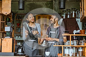 female barista smiling while pointing at the digital tablet