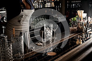 female barman with decolletage standing behind the bar coun