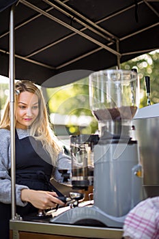 Female barrista making coffee for clients