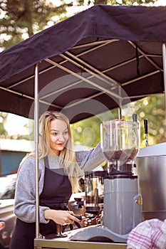 Female barrista making coffee for clients