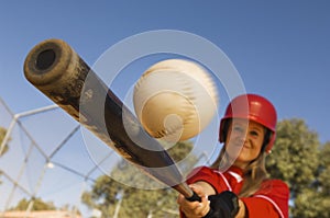 Female Baseball Player Hitting A Shot